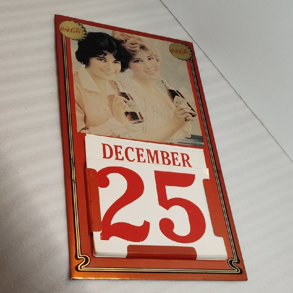 Coca-Cola Vintage Calendar with Red and Gold Accents